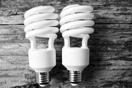 Energy saving lamp on the wood backgroundの写真素材