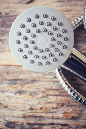 Shower head on wood backgroundの写真素材