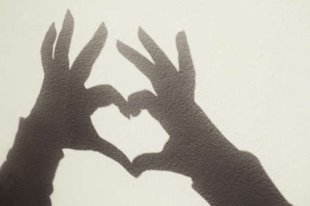Shadow of hands and heartの写真素材
