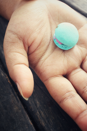 Macaroons on handの写真素材