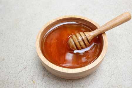 Fresh honey with honey dipperの写真素材