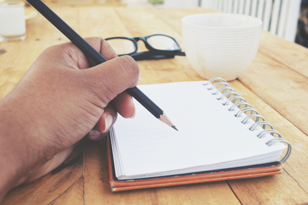 Woman with pen writing on paperの写真素材
