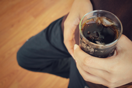 Woman drinking a cola drinkの写真素材