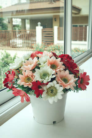 Beautiful of artificial flowers with windowの写真素材