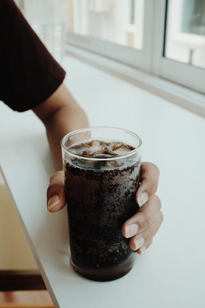 Woman drinking a cola drinkの写真素材