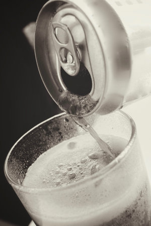 Pouring a glass of cola with ice cubes