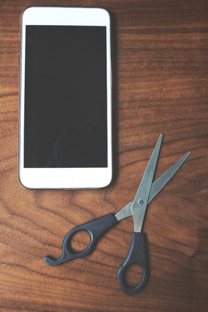 Hair cutting shears with smart phoneの写真素材