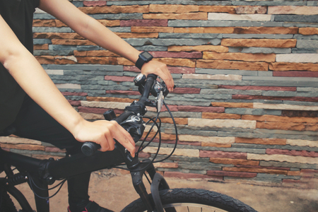Woman riding bicycle with smartwatchの写真素材
