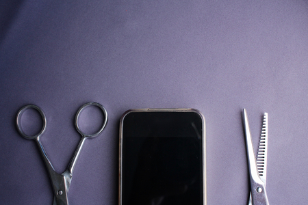Hair cutting shears with smart phoneの写真素材