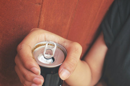 Cola can and hand