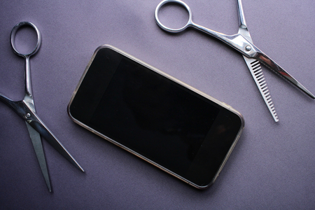 Hair cutting shears with smart phoneの写真素材