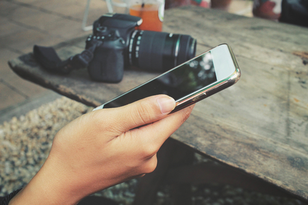 Woman using smart phone with cameraの写真素材