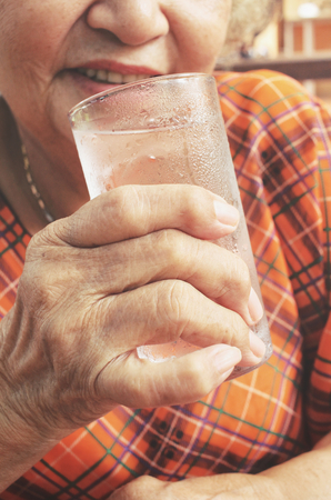 Senior drinking waterの写真素材