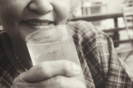 Senior drinking waterの写真素材