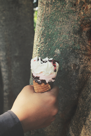 Ice cream cone on handの写真素材