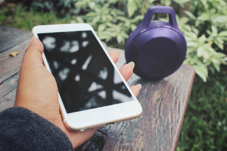 Woman using  speaker with smart phoneの写真素材