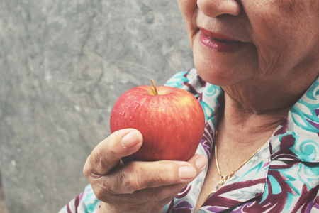 Senior woman holding appleの写真素材