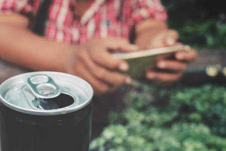Cola can with smart phoneの写真素材
