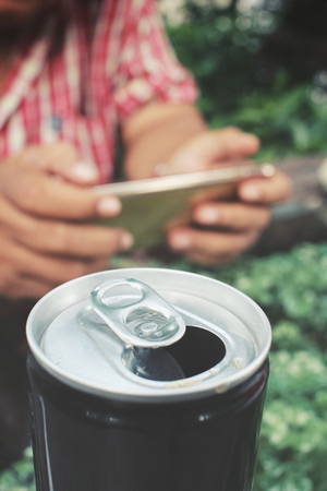 Cola can with smart phoneの写真素材