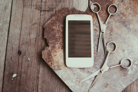 Hair cutting shears with smart phoneの写真素材