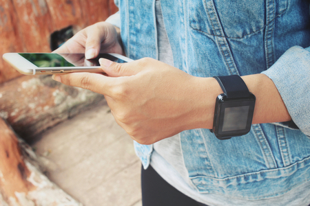 Smartwatch with smart phone on handの写真素材