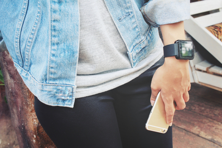 Smartwatch with smart phone on handの写真素材