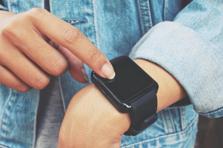 Smartwatch on hand with jeans jacket