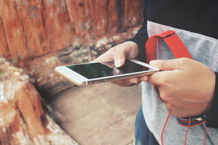 Woman listen to music on headphones with smart phoneの写真素材