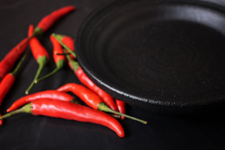 Red chili with empty plateの写真素材
