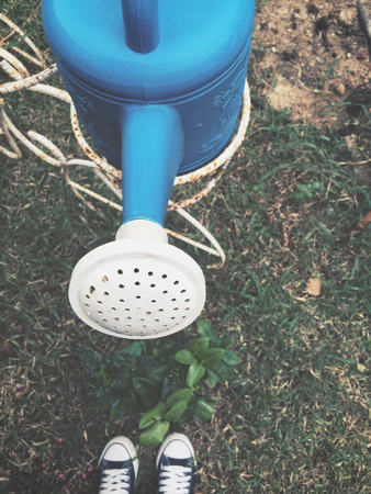 Selfie of shoes with watering canの写真素材