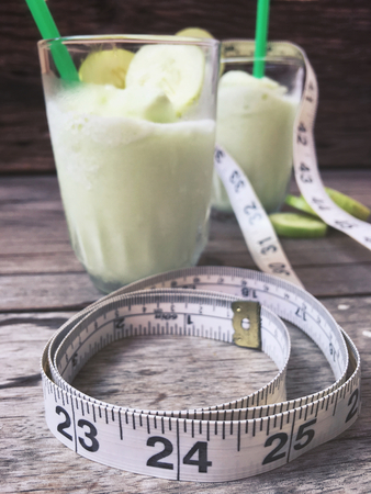 Green smoothie with tape measureの写真素材