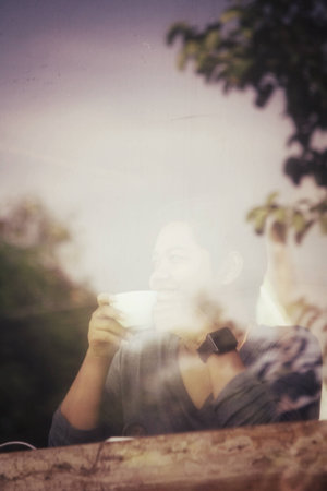 Woman drinking coffee sitting indoor at cafe