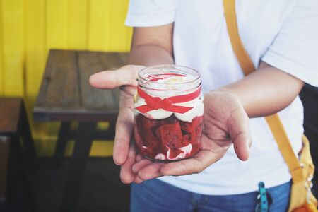 Red velvet cake on handsの写真素材