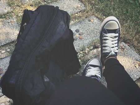 Selfie of woman tourist with a backpack and shoesの写真素材