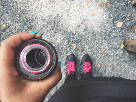 Selfie of cola drink bottle on hand