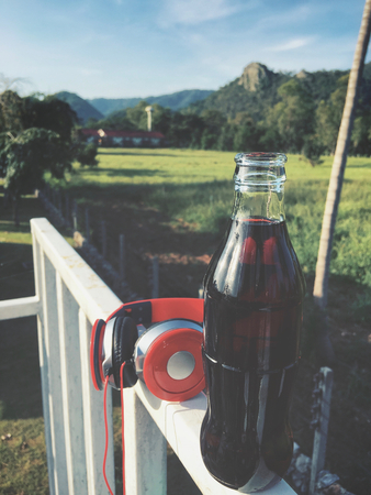 Cola drink bottle with headphonesの写真素材