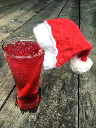 Red beverage with christmas hatの写真素材