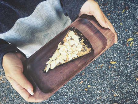 Chocolate brownies cake on handsの写真素材