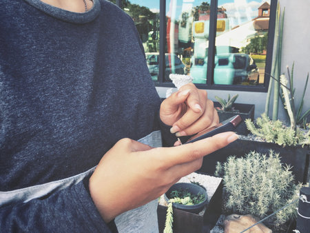 Woman using smart phone in garden