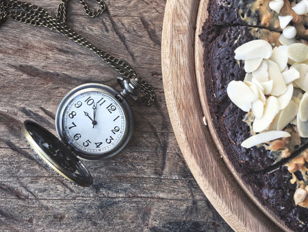 Chocolate brownies cake with vintage watch pocket