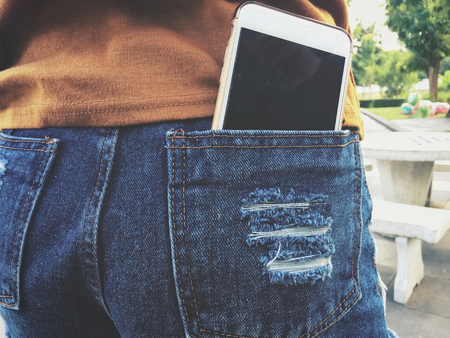 Smart phone in pocket jeansの写真素材