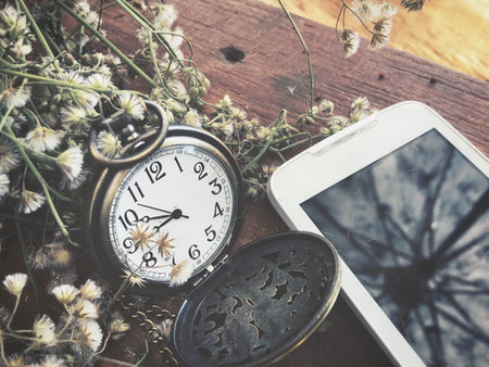 Vintage watch pocket with smart phoneの写真素材