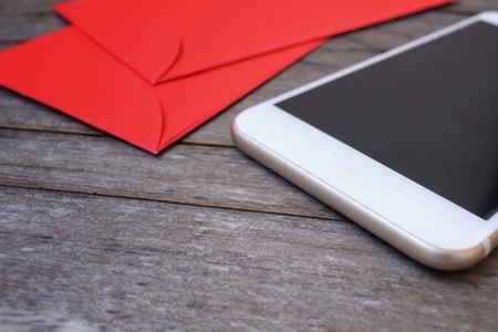 Red envelope in chinese new year festival with smart phoneの写真素材