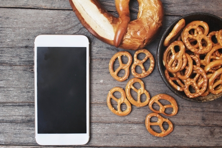 Pretzels with smart phoneの写真素材
