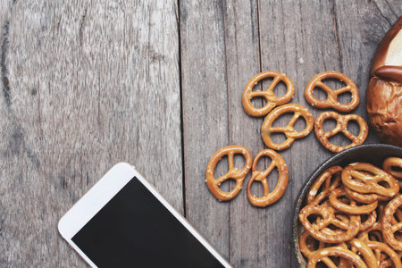 Pretzels with smart phoneの写真素材