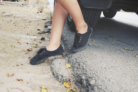 Leg with sneakers and carの写真素材