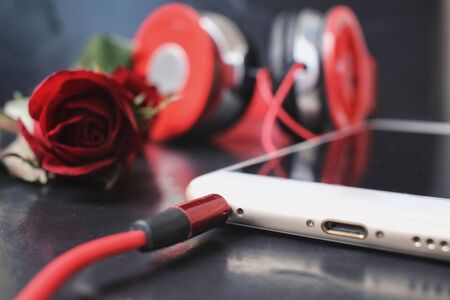 Red rose with earphone and smart phoneの写真素材