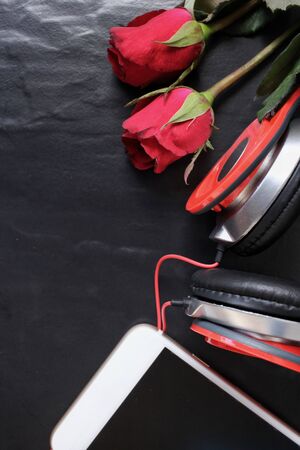 Red rose with earphone and smart phoneの写真素材