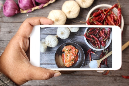 Taking a photo of kimchi korean food with smart phoneの写真素材
