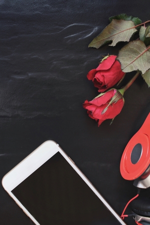 Red rose with earphone and smart phoneの写真素材